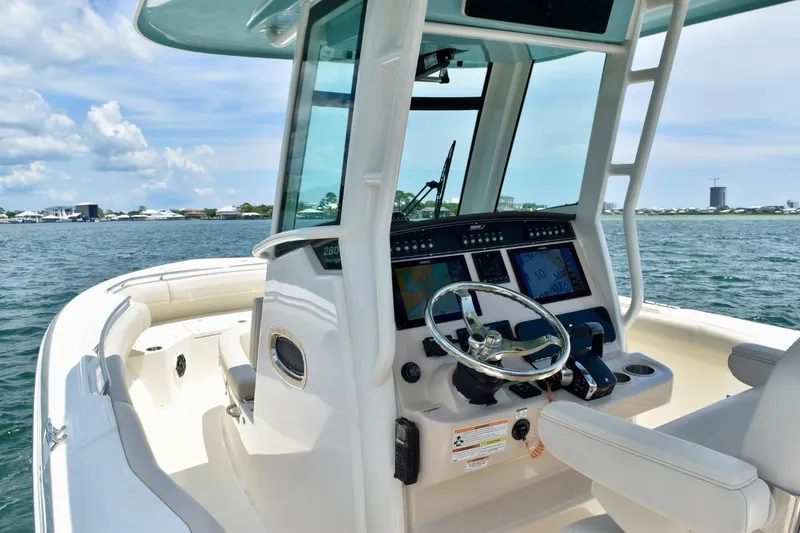 Slide: The Image of 2023 Boston Whaler 280 Outrage boat interior with modern helm and ocean view. - 14