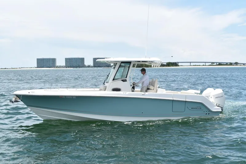 Slide: The Image of 2023 Boston Whaler 280 Outrage cruising on open water, showcasing sleek design and powerful engines. - 3