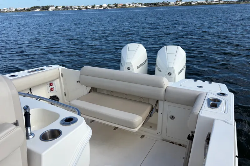 Slide: The Image of 2023 Boston Whaler 280 Outrage boat with dual Mercury engines on calm water. - 22
