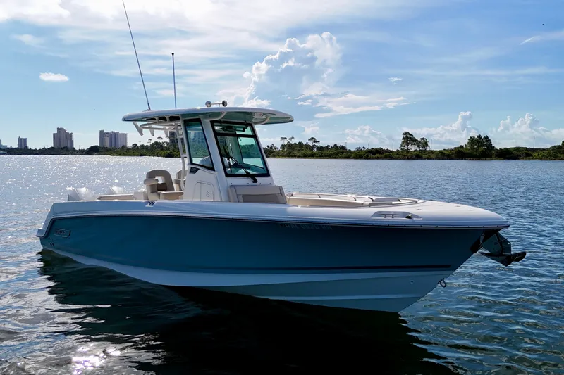Slide: The Image of 2023 Boston Whaler 280 Outrage boat on calm water under a clear sky. - 3