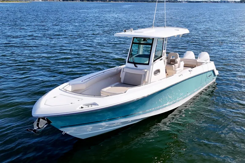Slide: The Image of 2023 Boston Whaler 280 Outrage boat on calm blue water. - 10