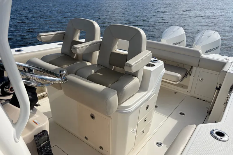 Slide: The Image of 2023 Boston Whaler 280 Outrage boat interior with dual seats and Mercury engines. - 19