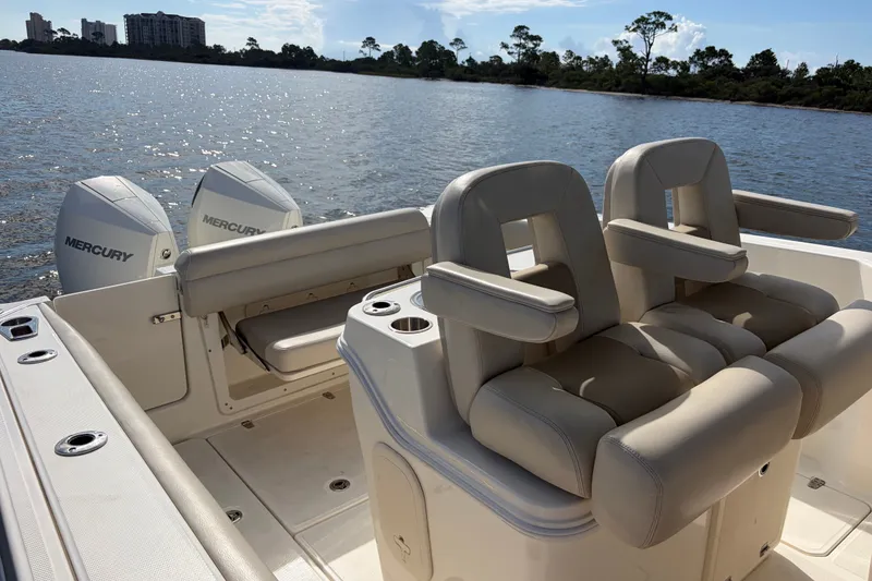 Slide: The Image of 2023 Boston Whaler 280 Outrage boat interior with Mercury engines on a sunny day. - 21
