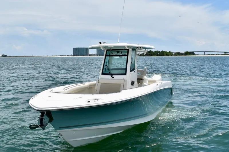 Slide: The Image of 2023 Boston Whaler 280 Outrage cruising on open water under a clear sky. - 7