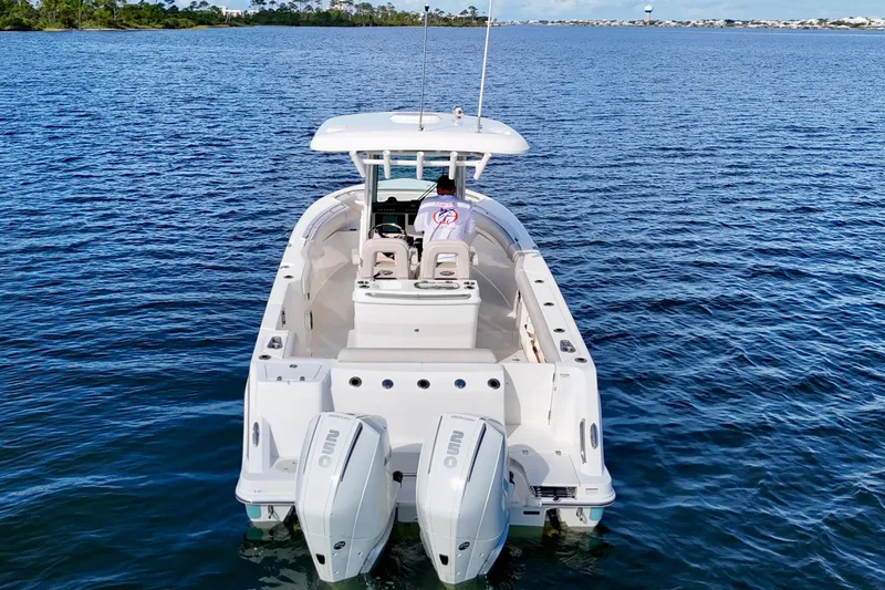 Slide: The Image of 2023 Boston Whaler 280 Outrage boat on open water, rear view. - 8