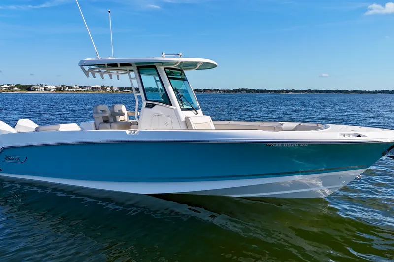 Slide: The Image of 2023 Boston Whaler 280 Outrage boat on calm water, clear sky background. - 1