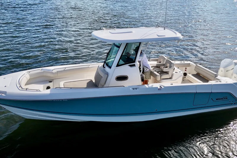 Slide: The Image of 2023 Boston Whaler 280 Outrage boat on water, featuring sleek design and spacious deck. - 4