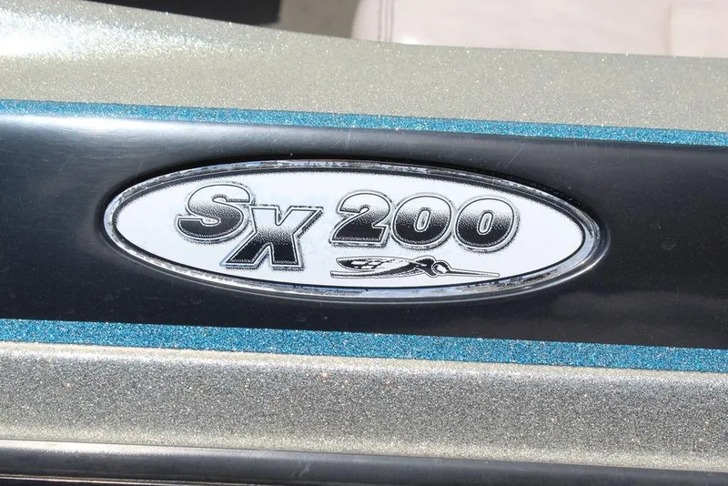 Slide: The Image of 2006 Skeeter SX200 boat emblem with metallic finish and blue accents. - 4