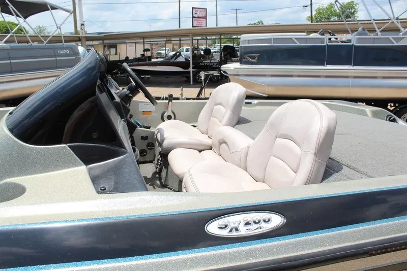 Slide: The Image of 2006 Skeeter SX200 boat interior with dual seats and steering console. - 8
