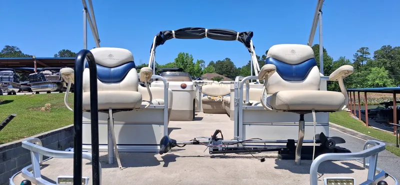 Slide: The Image of 2006 Tracker 24 ft Pontoon boat parked on concrete surface. - 10