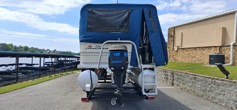 Slide: The Image of 2006 Tracker 24 ft Pontoon with blue cover at dock. - 13
