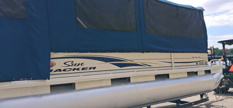 Slide: The Image of 2006 Tracker 24 ft Pontoon with blue cover. - 14