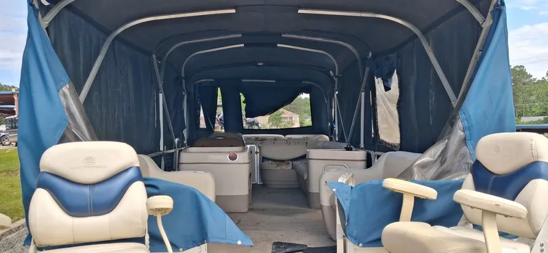 Slide: The Image of Interior of a 2006 Tracker 24 ft Pontoon boat with blue seating. - 15