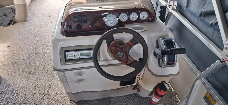 Slide: The Image of Interior view of a 2006 Tracker 24 ft Pontoon boat with steering console. - 3