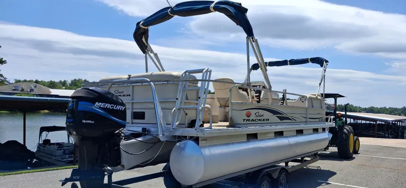 Slide: The Image of 2006 Tracker 24 ft pontoon boat parked by lakeside. - 4