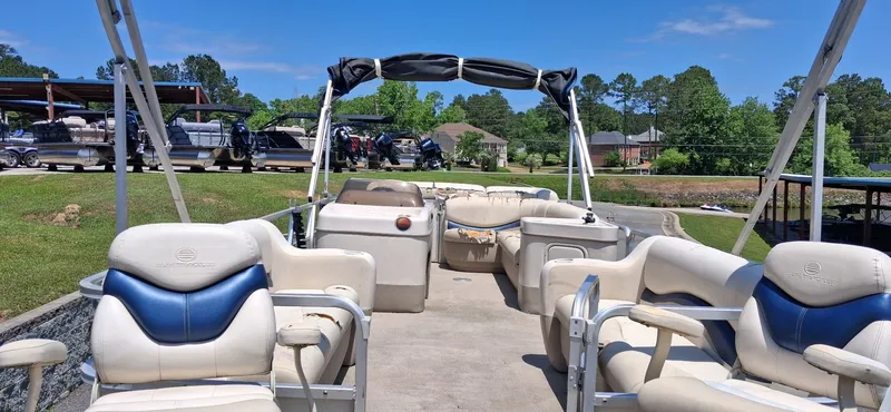 Slide: The Image of 2006 Tracker 24 ft Pontoon boat at a sunny dock. - 5