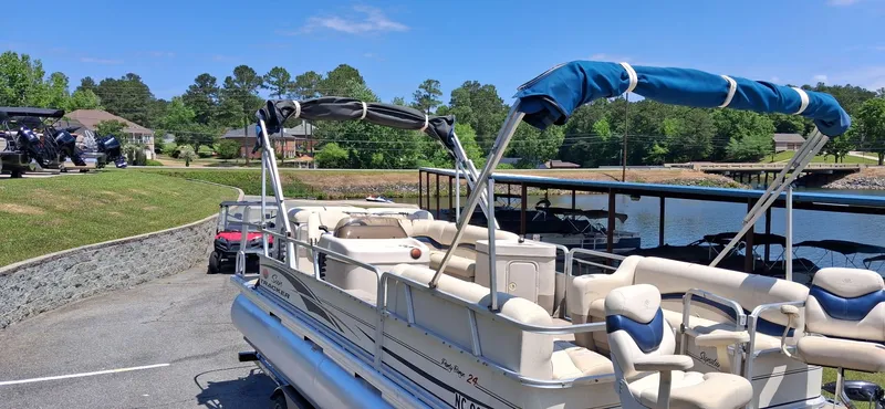Slide: The Image of 2006 Tracker 24 ft Pontoon parked by the lakeside. - 6