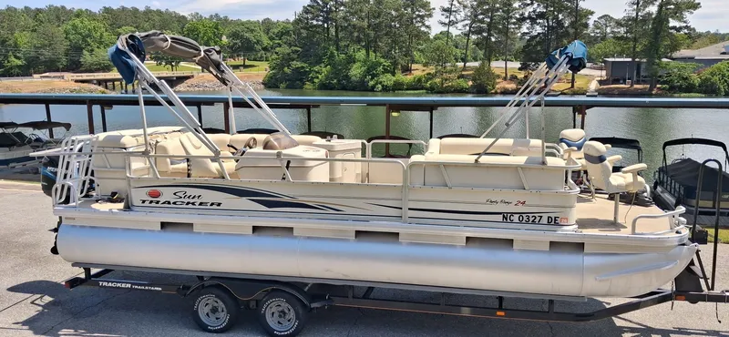 Slide: The Image of 2006 Tracker 24 ft Pontoon on trailer by lakeside. - 8