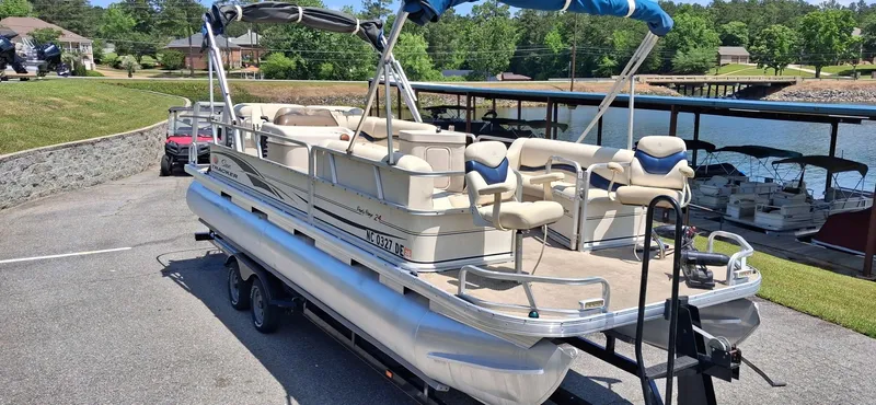 Slide: The Image of 2006 Tracker 24 ft Pontoon boat parked by the lakeside. - 9