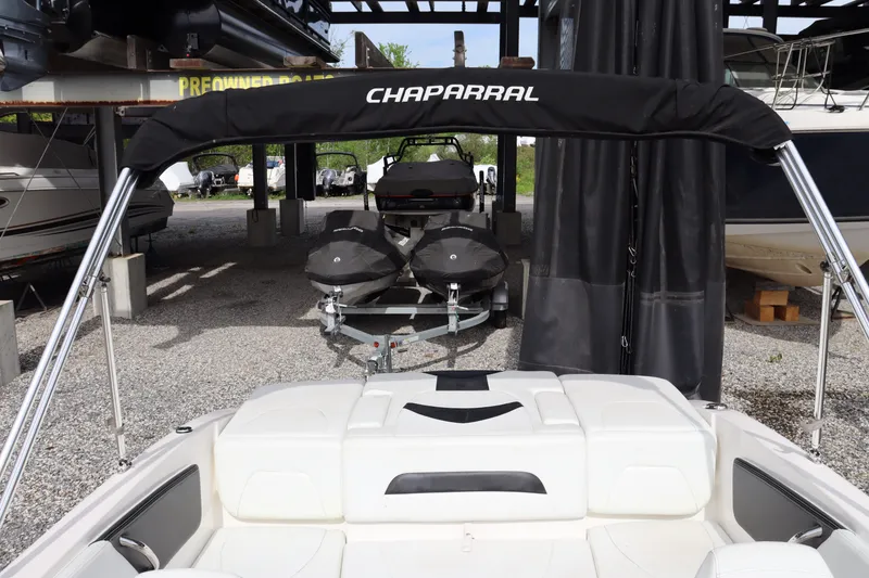 Slide: The Image of 2019 Chaparral 19 H2O boat with bimini top in storage facility. - 14