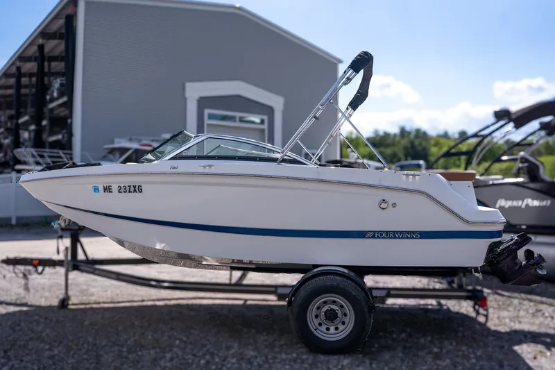 The Image of 2021 Four Winns HD1 LX boat on trailer outdoors. - 1