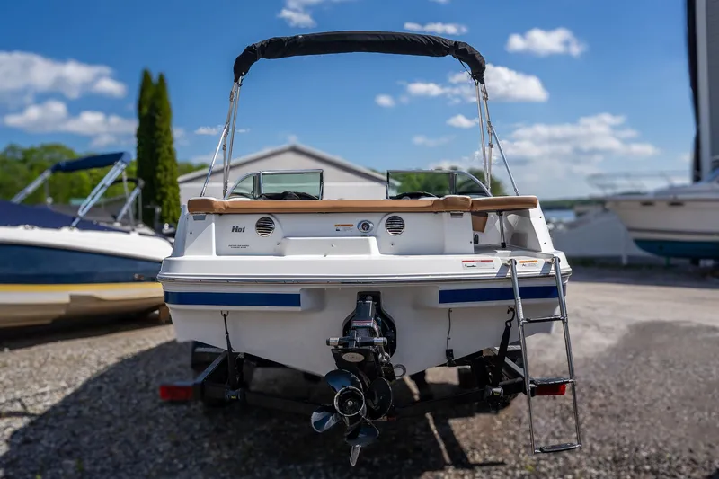 Slide: The Image of Rear view of a 2021 Four Winns HD1 LX boat outdoors. - 5