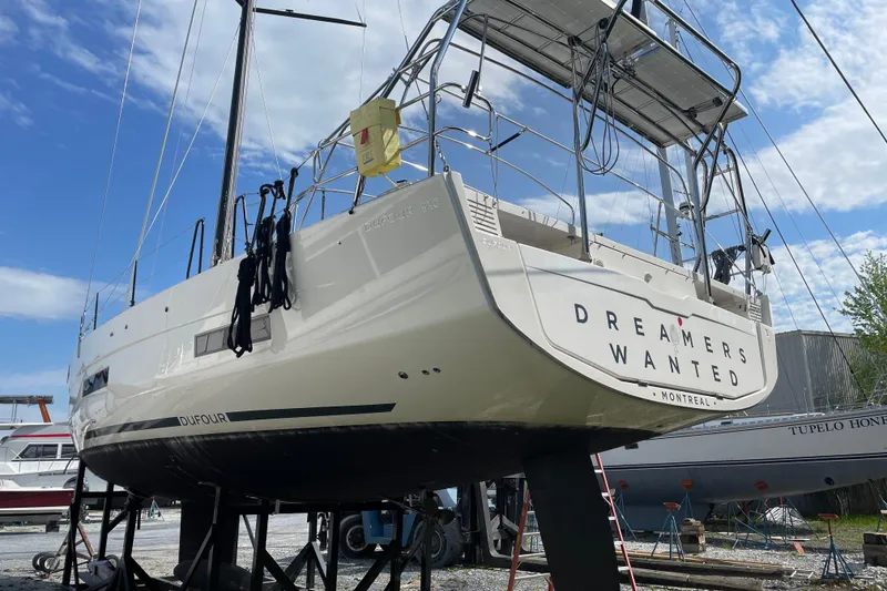 Slide: The Image of 2022 Dufour 530 sailboat on stands, "Dreamers Wanted" text, clear sky background. - 17