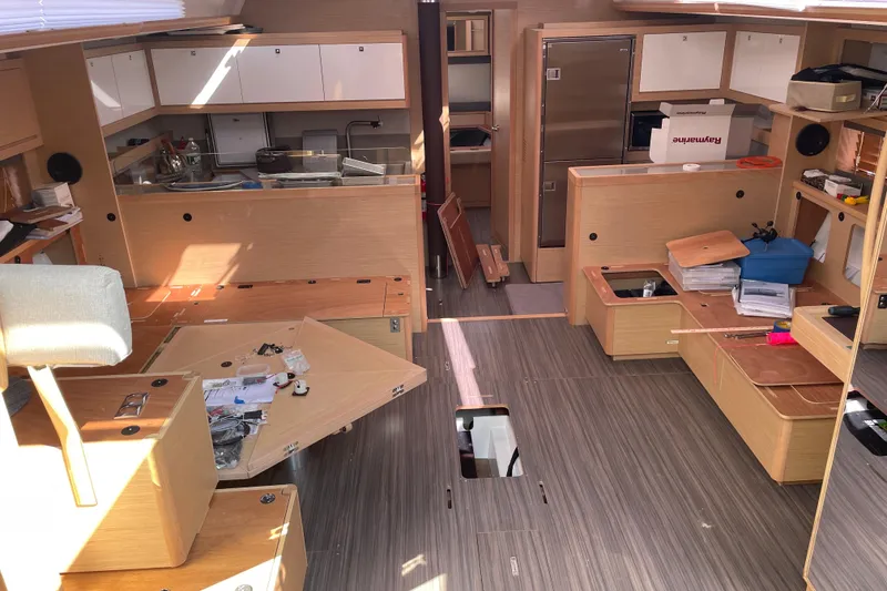 Slide: The Image of Interior of 2022 Dufour 530 yacht, featuring modern kitchen and spacious layout. - 18