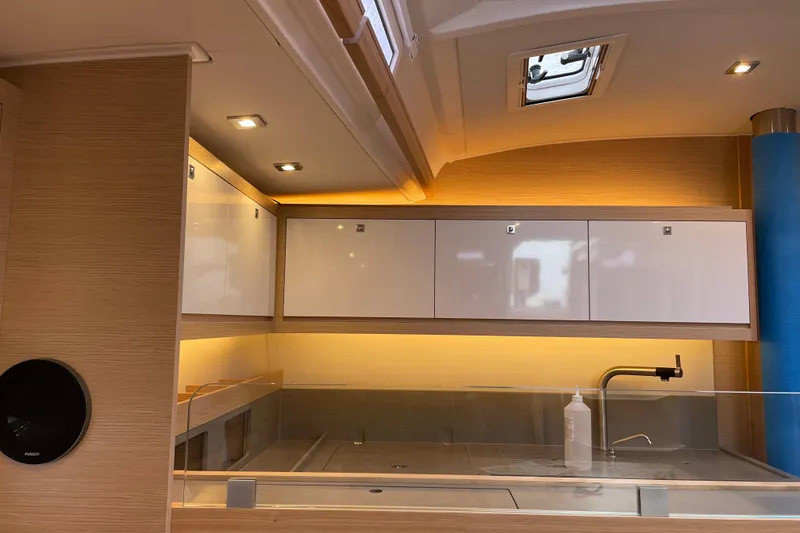 Slide: The Image of Modern kitchen interior of 2022 Dufour 530 yacht with sleek cabinetry and ambient lighting. - 20
