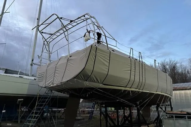 Slide: The Image of Covered 2022 Dufour 530 sailboat on stands, prepared for storage or maintenance. - 22