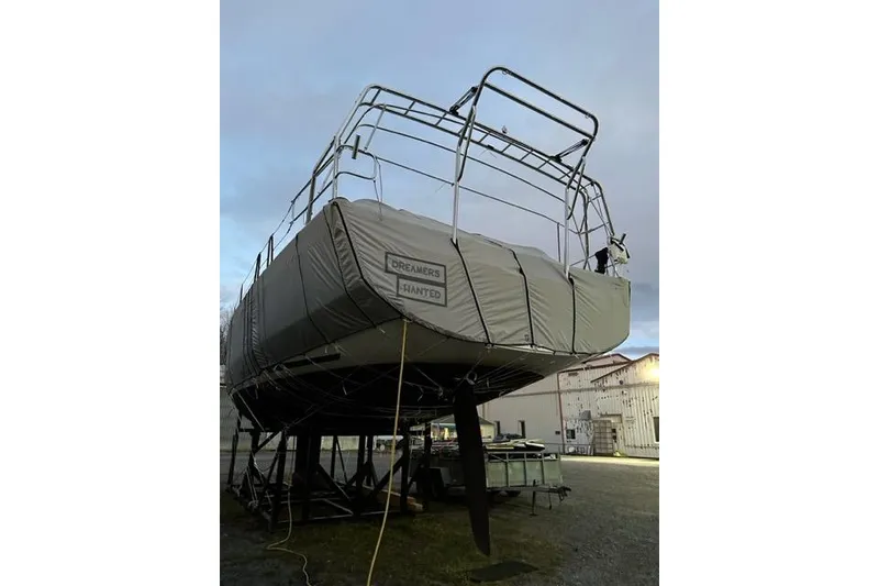 Slide: The Image of 2022 Dufour 530 sailboat covered and docked, labeled "Dreamers Wanted." - 24