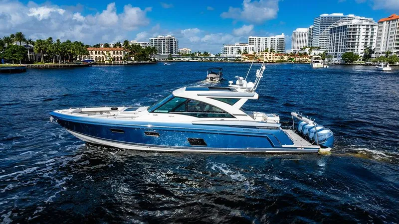 Slide: The Image of 2019 Formula 430 All Sport Crossover yacht cruising in a scenic waterfront cityscape. - 16