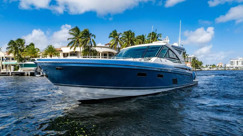 Slide: The Image of 2019 Formula 430 All Sport Crossover boat on water, palm trees in background. - 19
