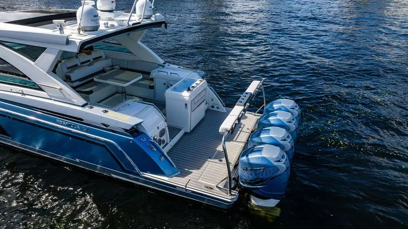 Slide: The Image of 2019 Formula 430 All Sport Crossover boat with four outboard engines on water. - 25
