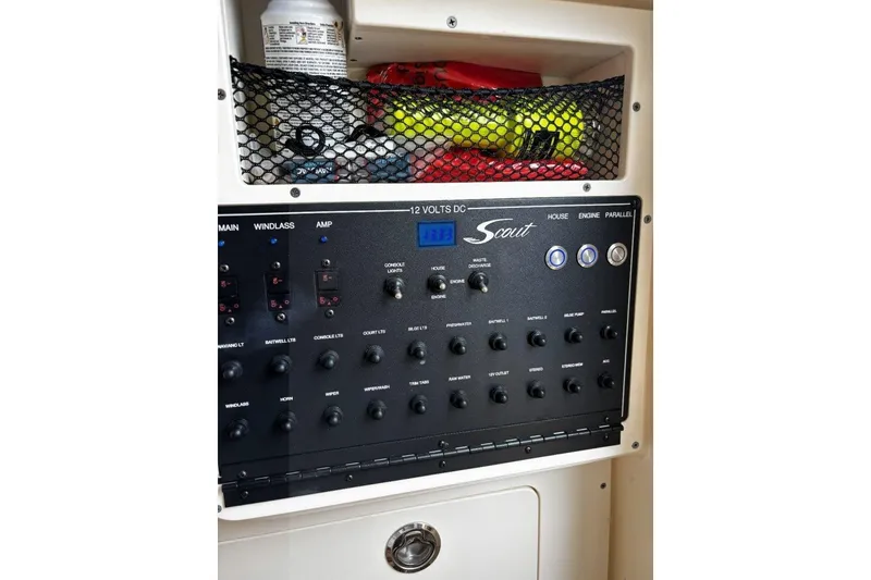 Slide: The Image of Control panel of a 2019 Scout 255 LXF boat with various switches and storage. - 11