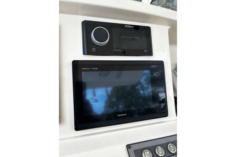 Slide: The Image of Control panel of 2019 Scout 255 LXF with Garmin GPS and Fusion audio system. - 12