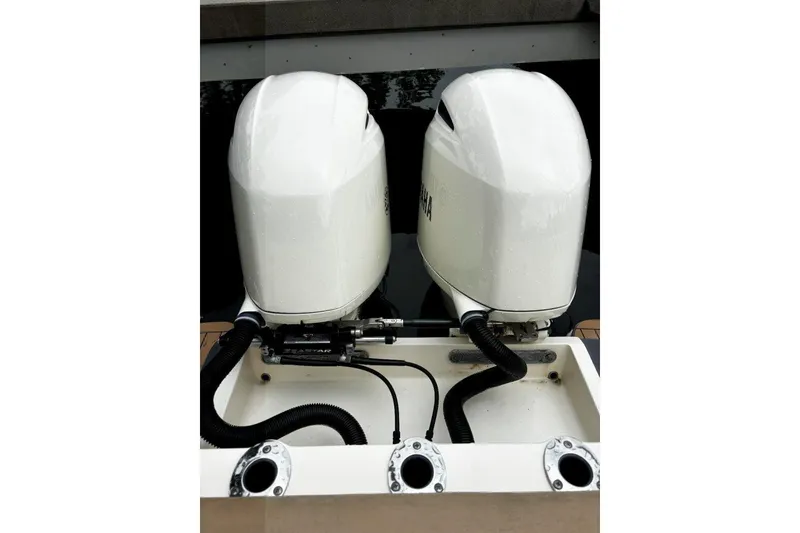 Slide: The Image of Twin outboard engines on a 2019 Scout 255 LXF boat, docked. - 14