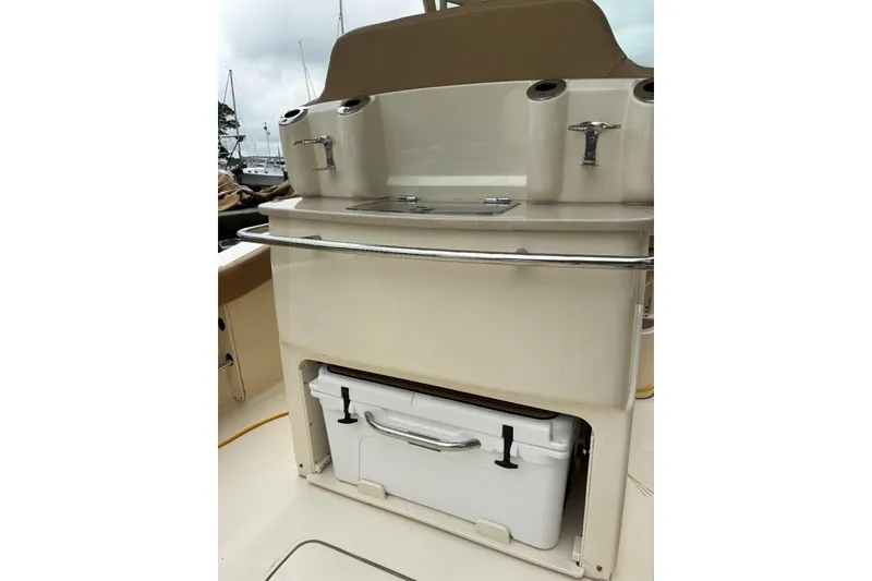 Slide: The Image of 2019 Scout 255 LXF boat interior with storage compartment and cooler. - 15