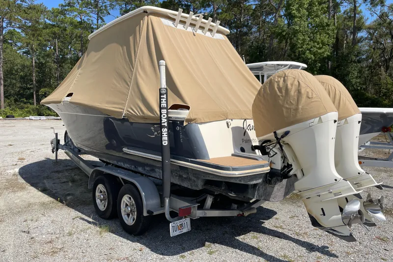 Slide: The Image of 2019 Scout 255 LXF boat with cover on trailer. - 16