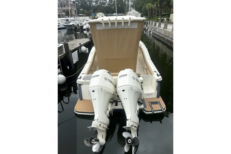 Slide: The Image of 2019 Scout 255 LXF boat with twin Yamaha engines docked at marina. - 3