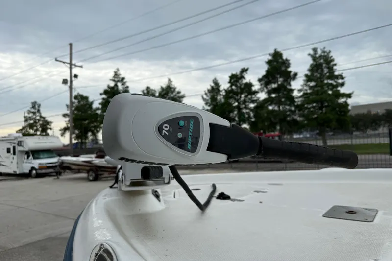 Slide: The Image of Trolling motor on 2002 Fishmaster 19 boat, parked outdoors under cloudy sky. - 10