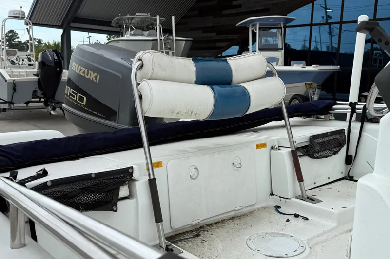 Slide: The Image of 2002 Fishmaster 19 boat interior with Suzuki 150 engine, featuring cushioned seating and storage compartments. - 15