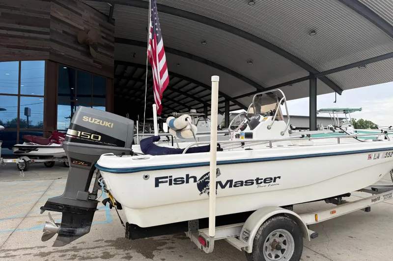 Slide: The Image of Boat dealership showcasing a 2002 Fishmaster 19 with Suzuki 150 engine. - 4