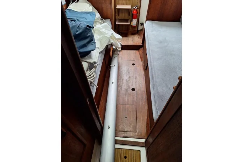 Slide: The Image of Interior of a 1976 Cape Dory 30 sailboat with wooden flooring and storage. - 10