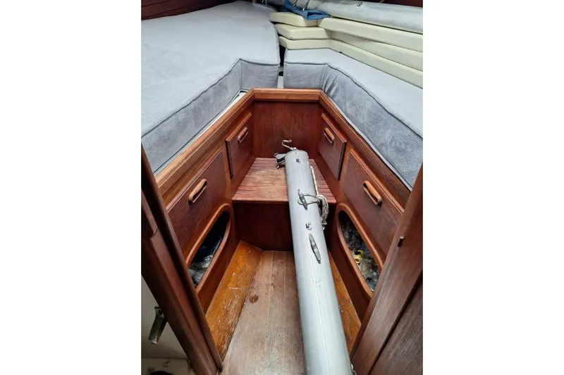 Slide: The Image of 1976 Cape Dory 30 sailboat interior with wooden cabinetry and cushioned seating. - 11