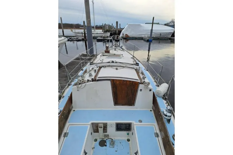 Slide: The Image of 1976 Cape Dory 30 sailboat docked at marina, showcasing deck and cabin details. - 5