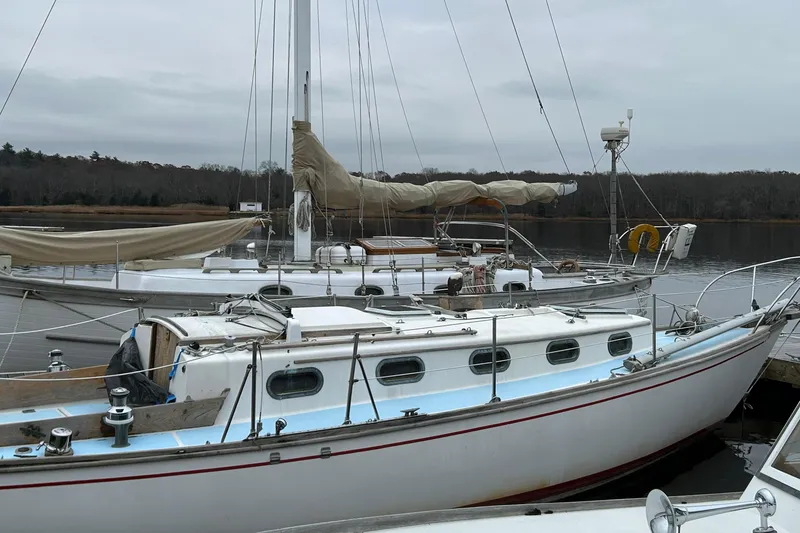 Slide: The Image of Sailboats docked at a marina, featuring a 1976 Cape Dory 30 model. - 7