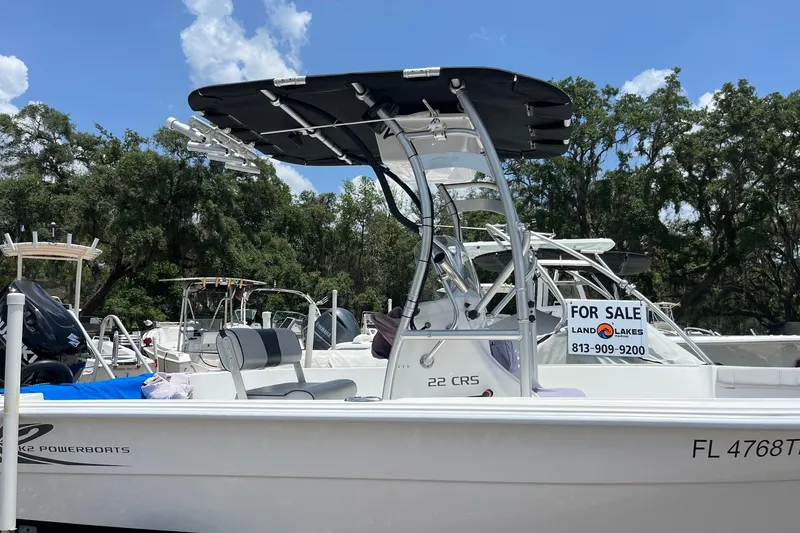 Slide: The Image of 2022 K2 Marine boat for sale, white with T-top, located in a marina. - 1