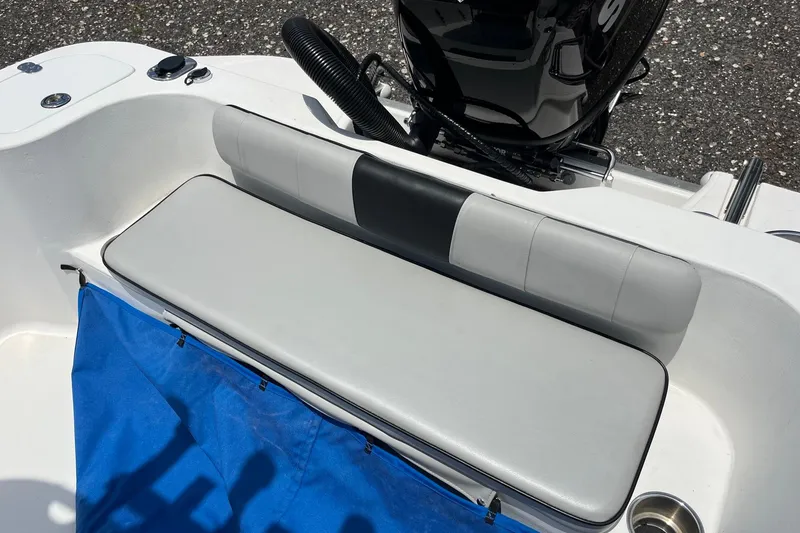 Slide: The Image of K2 Marine 2022 boat seat with blue cover and motor in background. - 10