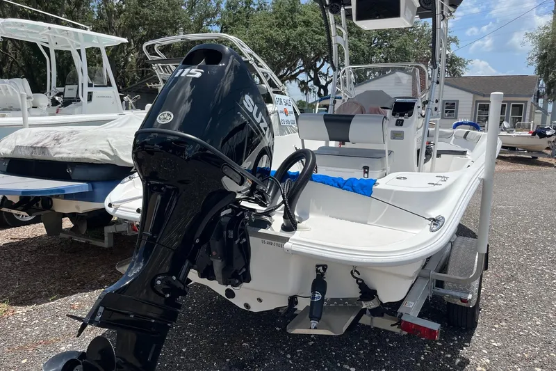 Slide: The Image of 2022 K2 Marine boat with Suzuki 115 engine, displayed outdoors for sale. - 2